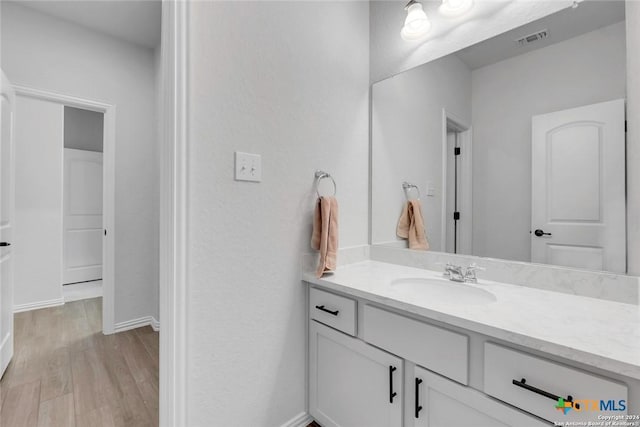 bathroom featuring wood-type flooring and vanity