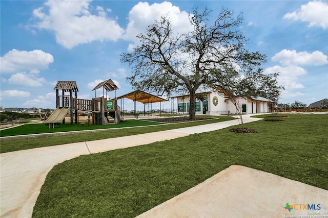 view of playground with a lawn