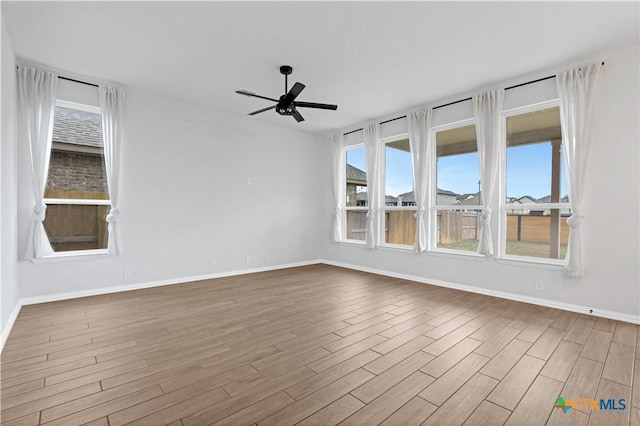 spare room featuring ceiling fan and hardwood / wood-style flooring