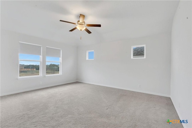 empty room featuring ceiling fan and light colored carpet