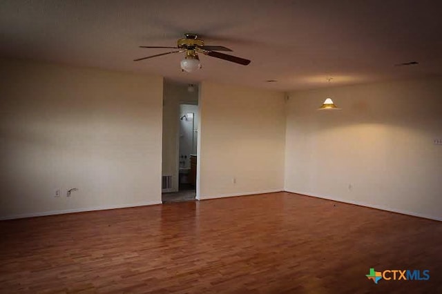 unfurnished room featuring dark hardwood / wood-style floors and ceiling fan