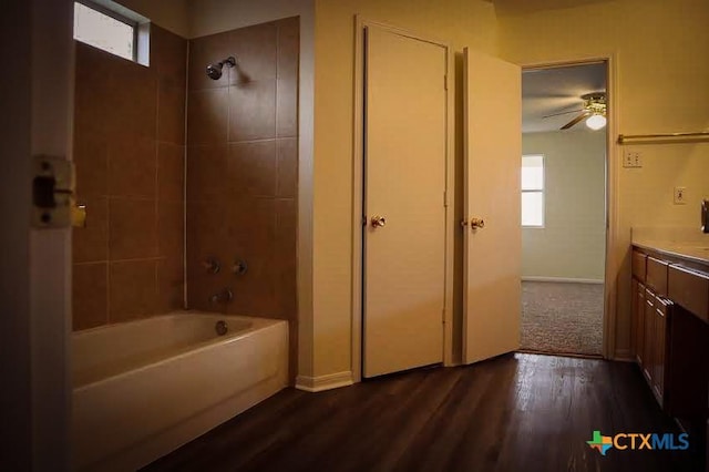 bathroom with vanity, ceiling fan, tiled shower / bath, and hardwood / wood-style floors