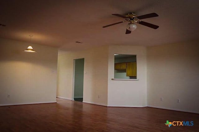 unfurnished room featuring dark hardwood / wood-style floors and ceiling fan