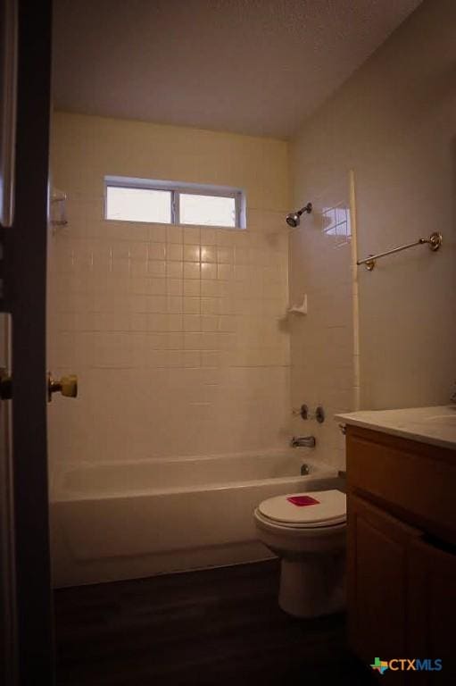 full bathroom with toilet, vanity, and shower / washtub combination