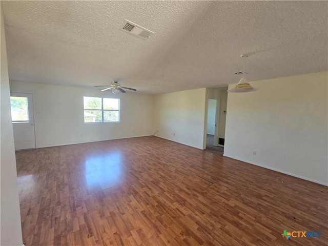 empty room featuring ceiling fan, wood-type flooring, and a textured ceiling