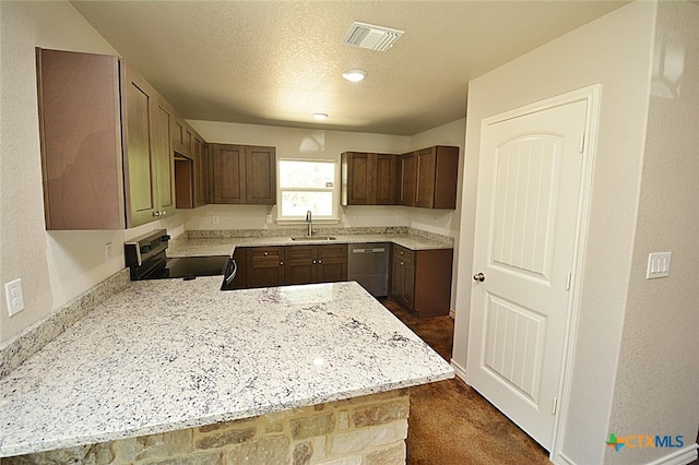 kitchen with sink, dark colored carpet, kitchen peninsula, a textured ceiling, and appliances with stainless steel finishes