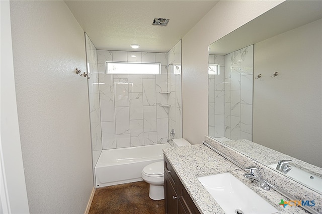 full bathroom featuring a textured ceiling, vanity, toilet, and tiled shower / bath