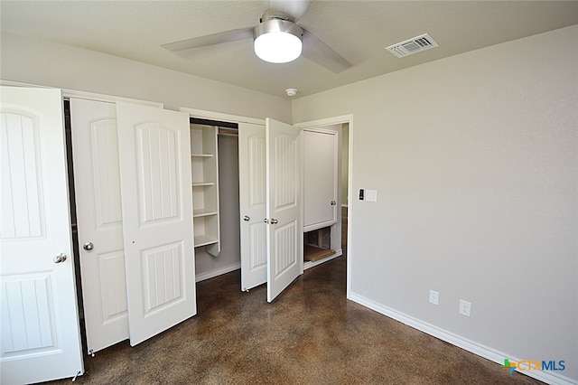 unfurnished bedroom featuring ceiling fan and dark carpet