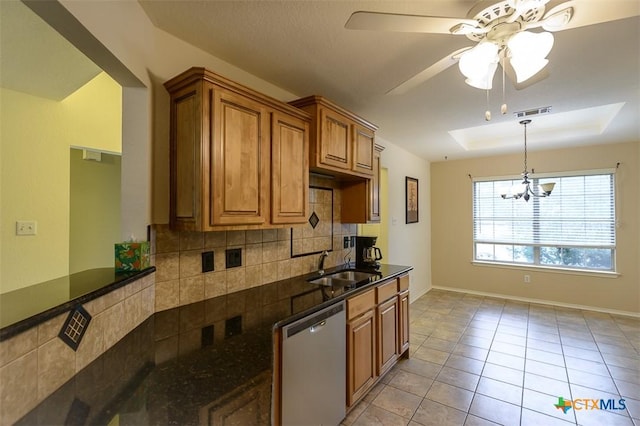 408 Sterling Manor Ct, Temple, TX 76502 - kitchen featuring dishwasher, decorative backsplash, a chandelier, brown cabinets, and ceiling fan