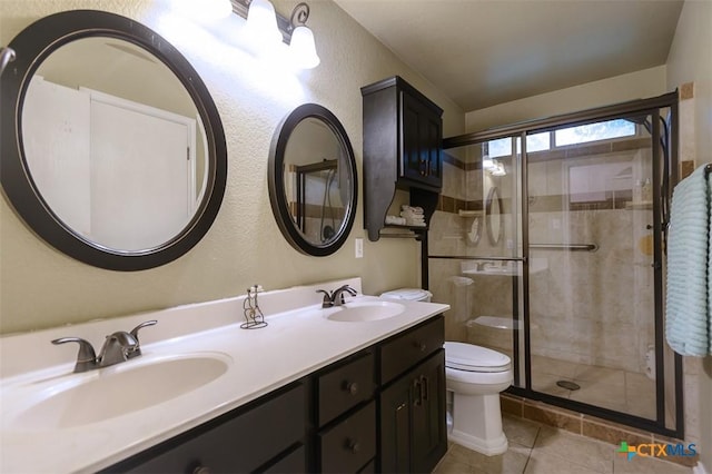 408 Sterling Manor Ct, Temple, TX 76502 - full bathroom with a shower stall, double vanity, tile patterned floors, and a textured wall