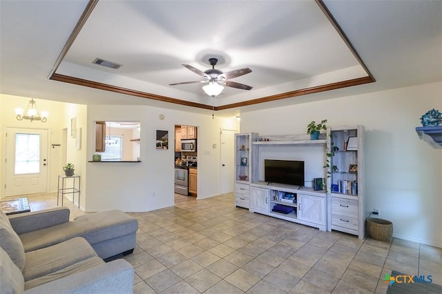 408 Sterling Manor Ct, Temple, TX 76502 - living room featuring a tray ceiling, a chandelier, and ceiling fan