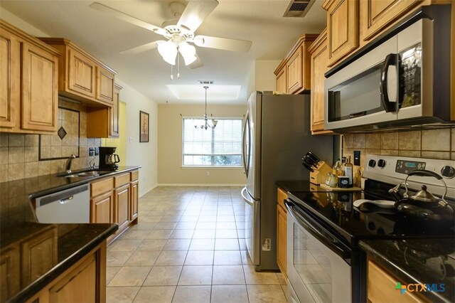 408 Sterling Manor Ct, Temple, TX 76502 - kitchen with appliances with stainless steel finishes, a ceiling fan, backsplash, and brown cabinets