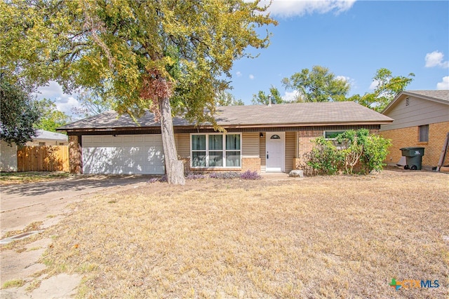 ranch-style home with a garage and a front yard