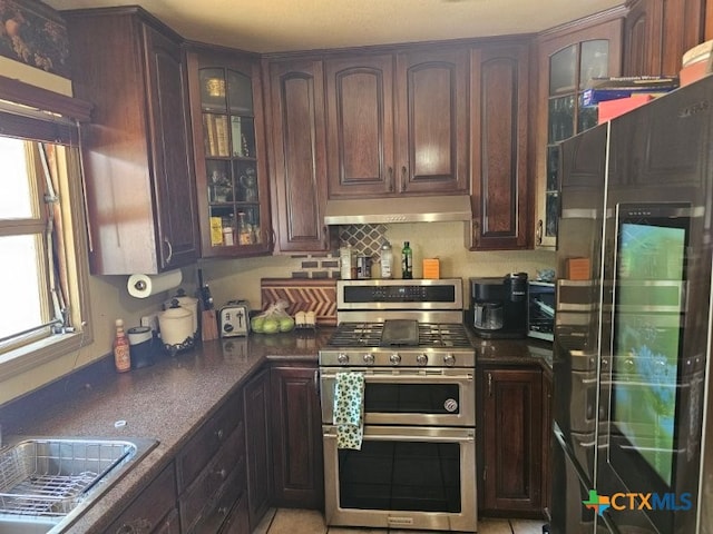 263 E Garden St, New Braunfels, TX 78130 - kitchen featuring double oven range, under cabinet range hood, fridge with ice dispenser, dark countertops, and a sink