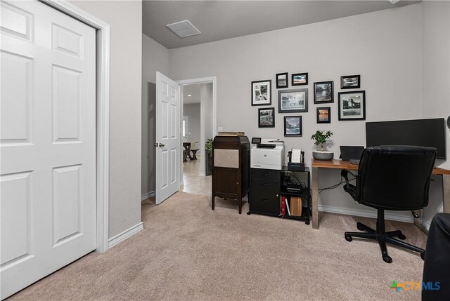 carpeted home office featuring visible vents and baseboards