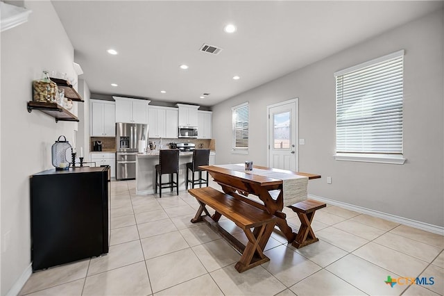 dining space with recessed lighting, light tile patterned flooring, baseboards, and visible vents