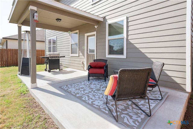 view of patio featuring area for grilling and fence