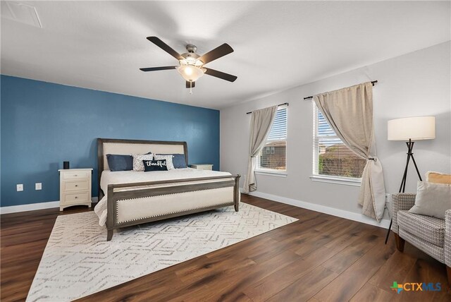 bedroom with wood finished floors, baseboards, and ceiling fan