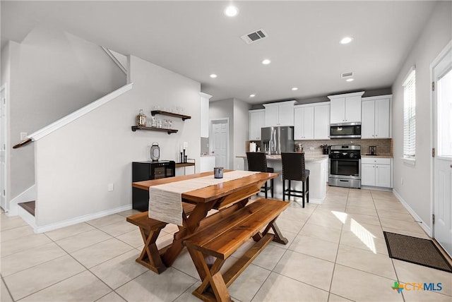 dining room featuring light tile patterned floors, visible vents, recessed lighting, and baseboards