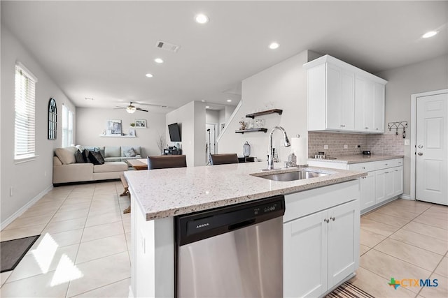 kitchen featuring dishwasher, light tile patterned flooring, visible vents, and a sink