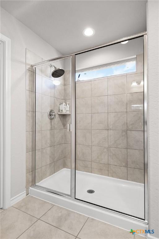 bathroom featuring tile patterned floors and a shower stall