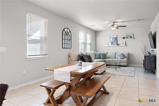 dining area with light tile patterned floors, visible vents, and a ceiling fan