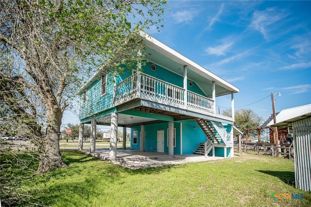 back of house featuring stairs, a patio, a yard, and a deck