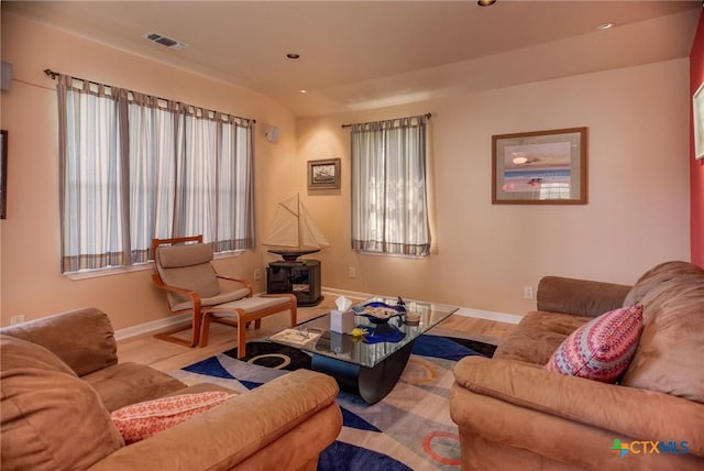 living room with baseboards, visible vents, wood finished floors, and recessed lighting