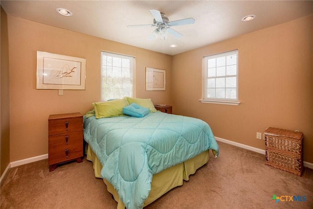 bedroom with light carpet, recessed lighting, and baseboards