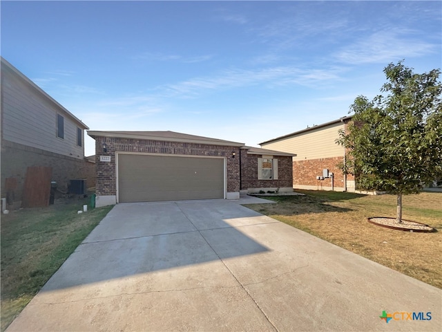 single story home with a garage, a front yard, and central AC