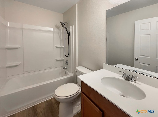 full bathroom featuring shower / tub combination, vanity, hardwood / wood-style flooring, and toilet