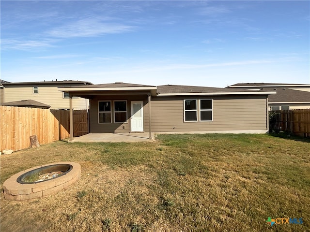 rear view of property with a yard and a patio area