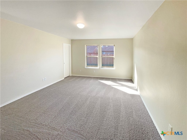 unfurnished room featuring carpet