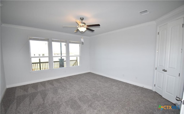 carpeted spare room with ceiling fan and crown molding