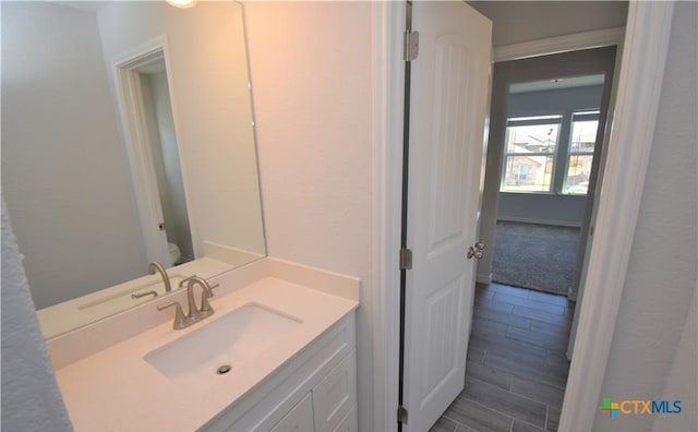 bathroom with vanity and toilet