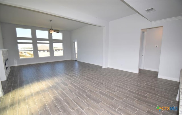 unfurnished living room featuring hardwood / wood-style flooring, ceiling fan, and ornamental molding