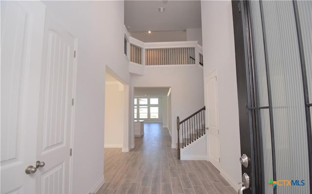 foyer featuring light hardwood / wood-style flooring and a towering ceiling