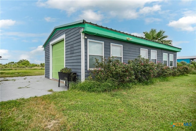 126 Washington Ave, Port Lavaca, TX 77979 - view of property exterior featuring a lawn and metal roof