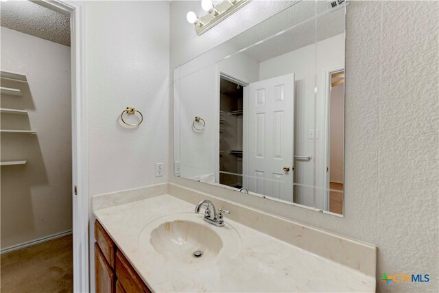 bathroom with vanity and a textured ceiling