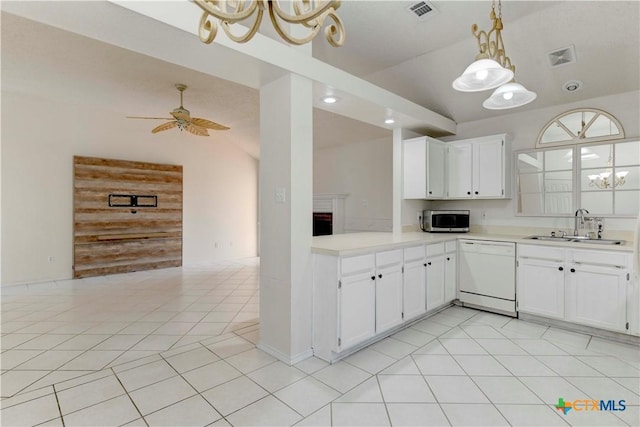 kitchen with white cabinets, dishwasher, sink, and vaulted ceiling