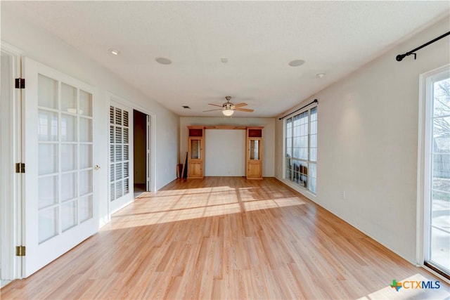 interior space with ceiling fan