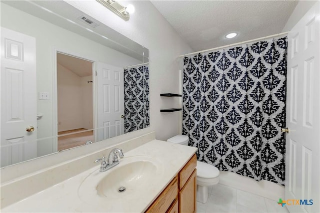 bathroom with tile patterned floors, a textured ceiling, toilet, vanity, and a shower with shower curtain