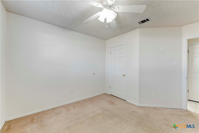 carpeted empty room featuring a textured ceiling and ceiling fan