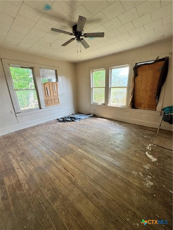 205 S Chestnut, Lampasas, TX 76550 - empty room featuring hardwood / wood-style flooring, healthy amount of natural light, and a ceiling fan