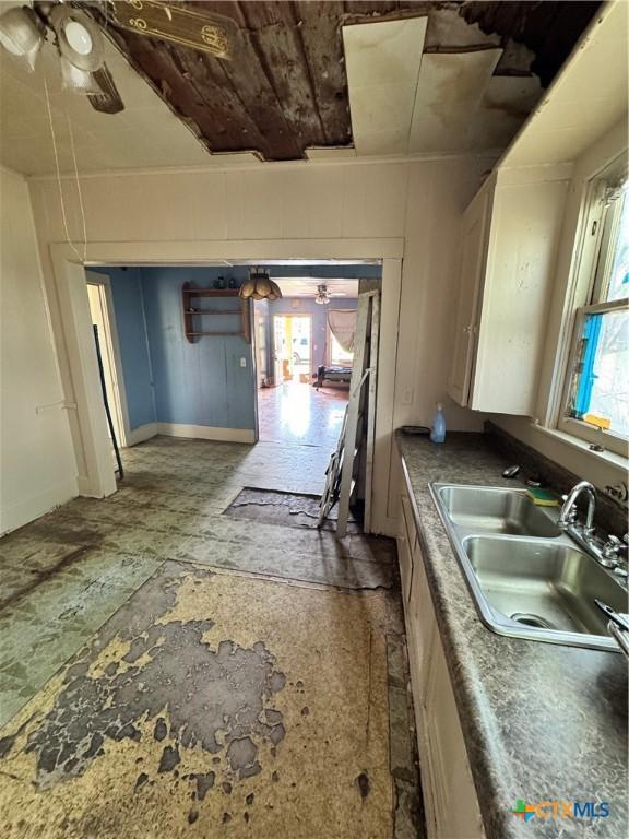 205 S Chestnut, Lampasas, TX 76550 - kitchen with a sink, ceiling fan, and baseboards