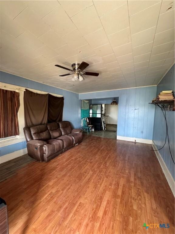 205 S Chestnut, Lampasas, TX 76550 - living area featuring wood finished floors, ceiling fan, and baseboards