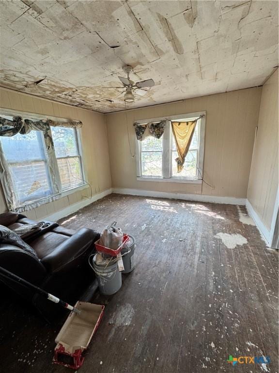 205 S Chestnut, Lampasas, TX 76550 - unfurnished living room featuring plenty of natural light, baseboards, hardwood / wood-style floors, and a ceiling fan