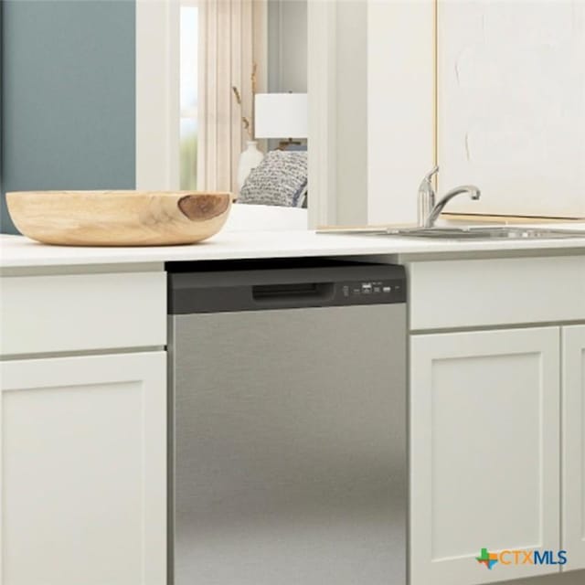 kitchen with a sink, dishwasher, white cabinets, and light countertops