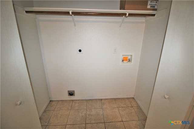 clothes washing area featuring light tile patterned flooring, hookup for a washing machine, and electric dryer hookup