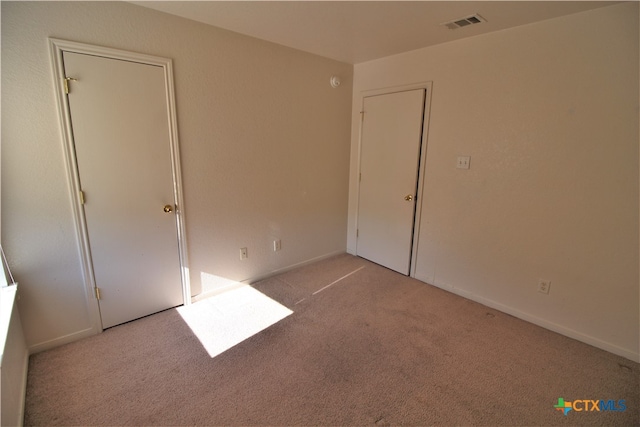 unfurnished bedroom with light carpet